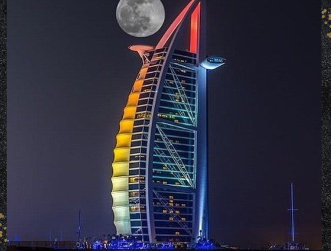 The Burj Al Arab hotel illuminated by vibrant lights, showcasing its stunning architecture and creating a captivating ambiance. "Best hotel in Dubai"